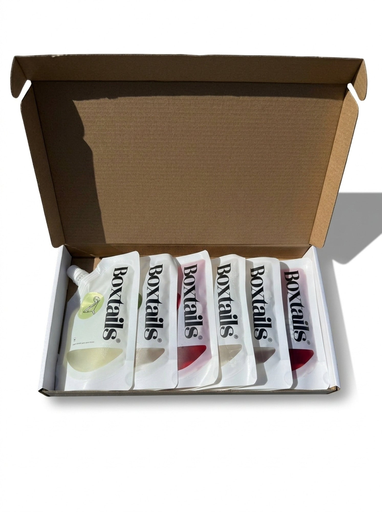 An open Boxtails delivery box containing six cocktail pouches
